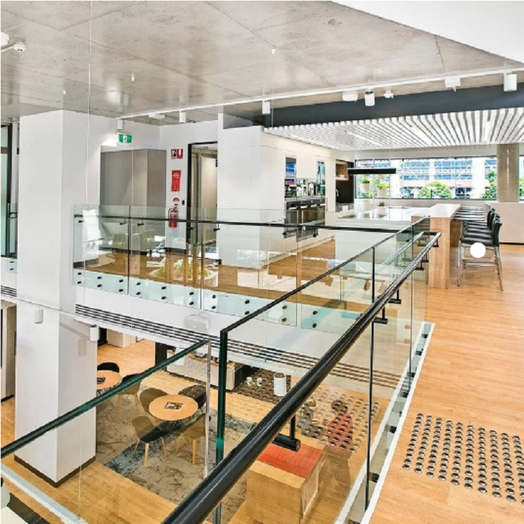 Interior modern black standoff glass railing with side handrail 
