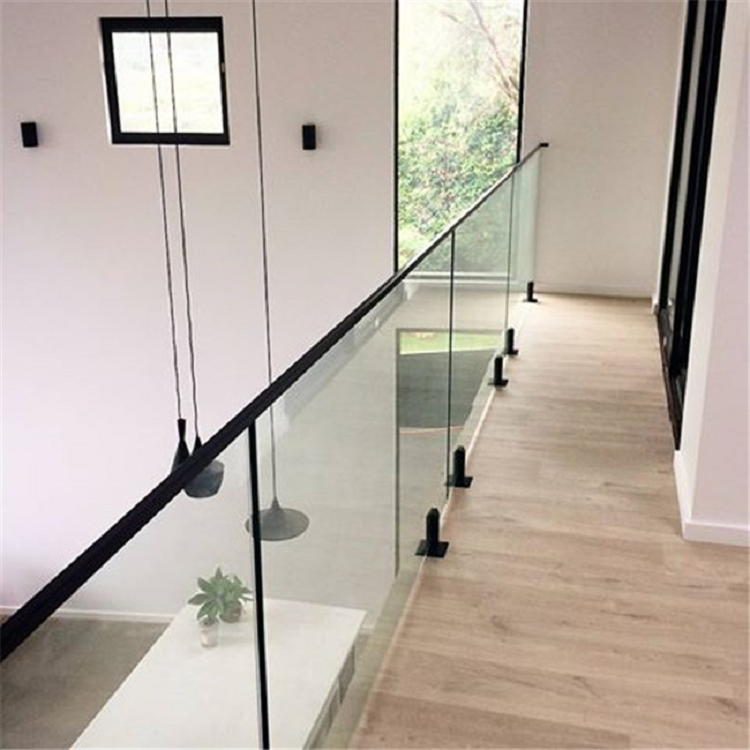 Modern indoor opening glass railing with black metal hardware 